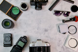Flat lay with camera lenses and accessories on white background
