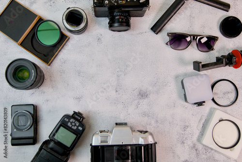 Flat lay with camera lenses and accessories on white background photo