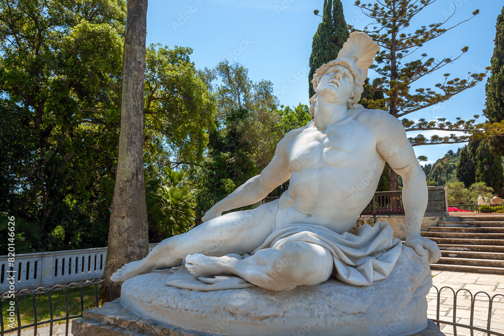Dying Achilles, the famous statue at the gardens of the Achilleion Palace in Corfu, Greece, depicting the Greek hero scrambling and trying to remove the fatal arrow from his heel.  