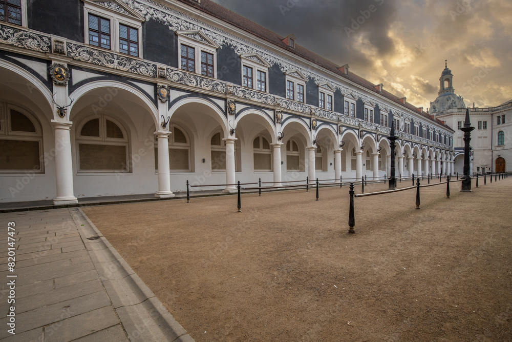 The stable yard was part of the residential palace and served as a venue for large equestrian tournaments. Historical architecture in white. Taken in the morning in Dresden, Saxony, Germany The stable yard was part of the residential palace and served as a venue for large equestrian tournaments. Historical architecture in white. Taken in the morning in Dresden, Saxony, Germany