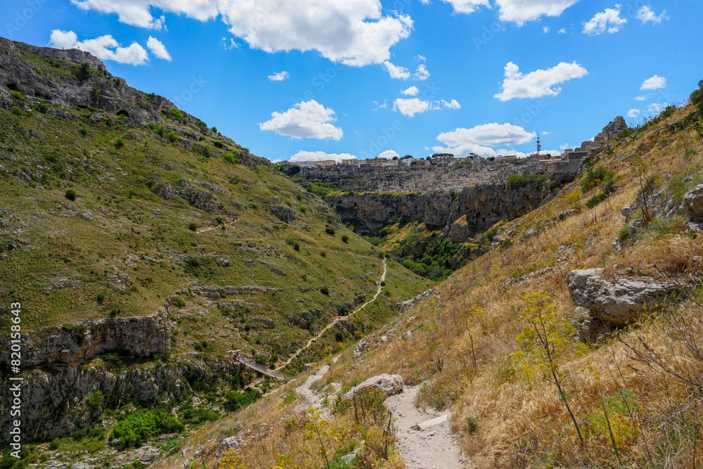 Hiking trail through dramatic Gravina gorge in Matera Italy Hiking trail through dramatic Gravina gorge in Matera Italy