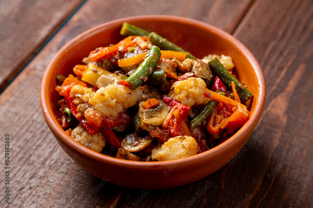 vegetables stewed in spices in a clay bowl on the table vegetables stewed in spices in a clay bowl on the table