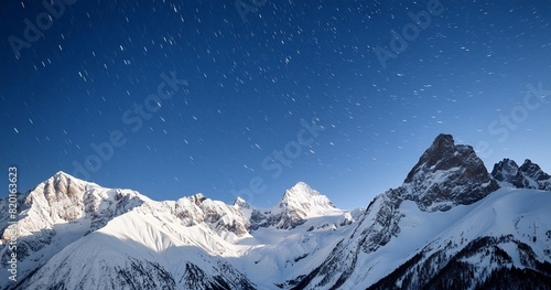 A snowy mountain range with sharp peaks covered in a blanket of fresh snow, under a clear starry night sky