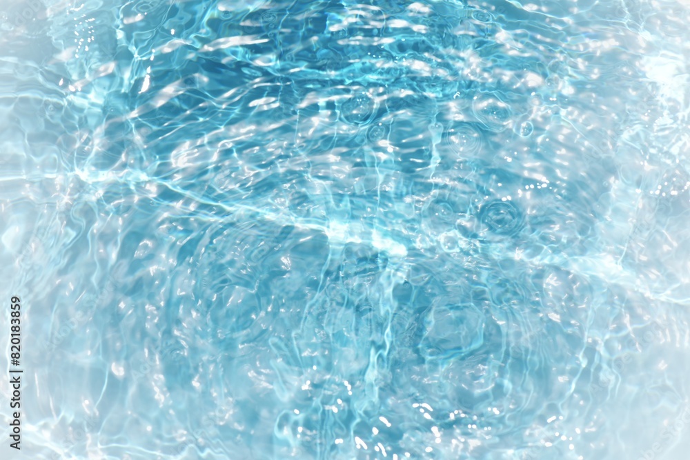 Blue water with ripples on the surface. Defocus blurred transparent blue colored clear calm water surface texture with splashes and bubbles. Water waves with shining pattern texture background.	