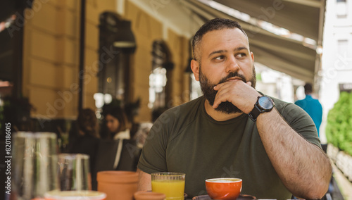Arabic appearance modern young man thinking about something problems at city street, minds concept