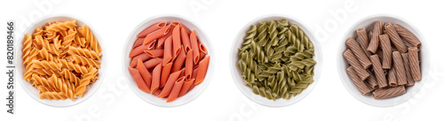 Gluten-free pasta variants in white bowls. Four different types of noodles made without wheat flour. From left to right chickpea fusilli, red lentil penne, green pea fusilli and buckwheat tortiglioni.
