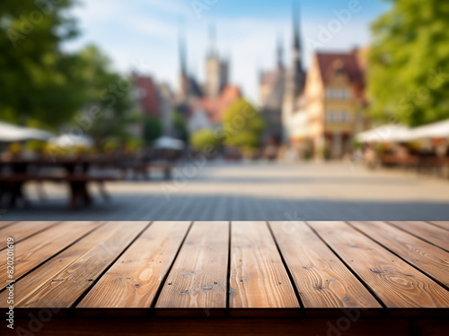 An exuberant cityscape forms a blurred backdrop behind an empty wooden table