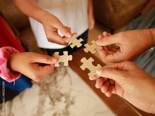 A woman hands connecting jigsaw puzzle   success and strategy concept.