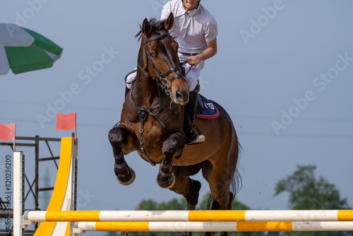 Show jumping competition on horseback. Horse Jumping, Equestrian Sports, Show Jumping themed photo. 