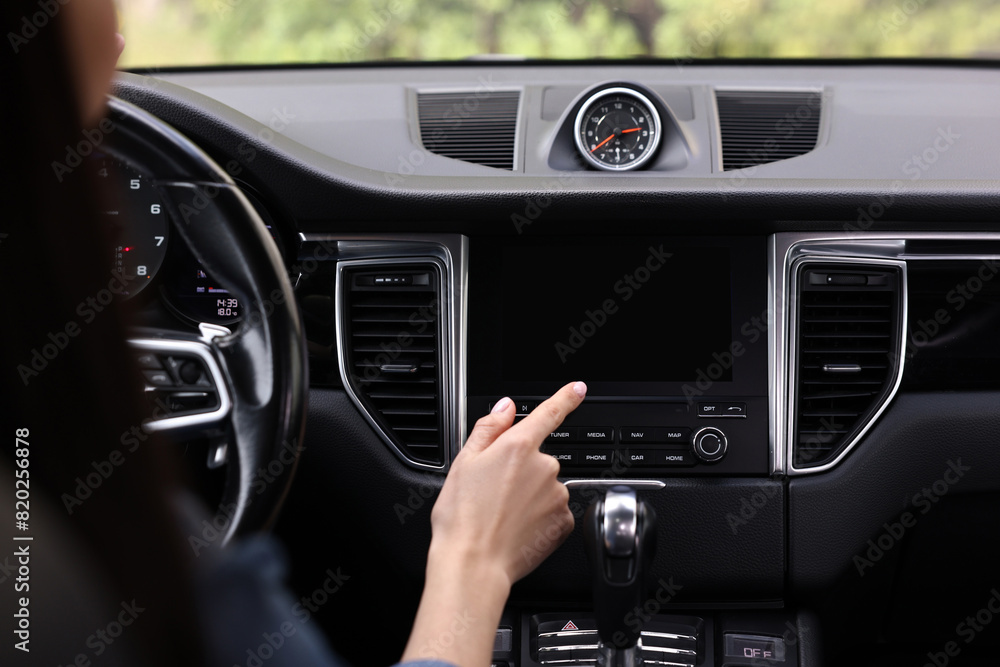 Woman using navigation system while driving her car, closeup Woman using navigation system while driving her car, closeup