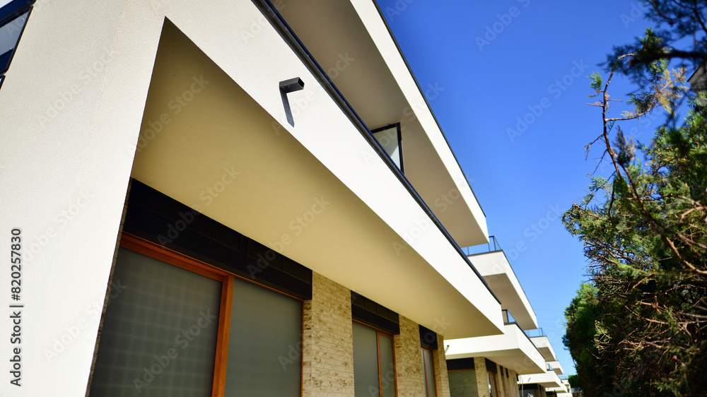 Fototapeta premium Eco-friendly living in city with greens. Eco apartment building saving energy and fresh air concept. 