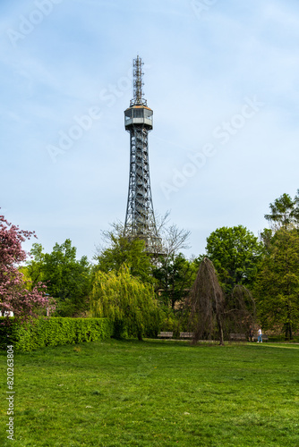 Prague, Czech Republic - April 14, 2023: Petrin observation tower in Prague located in a park among trees on a hill above the city.