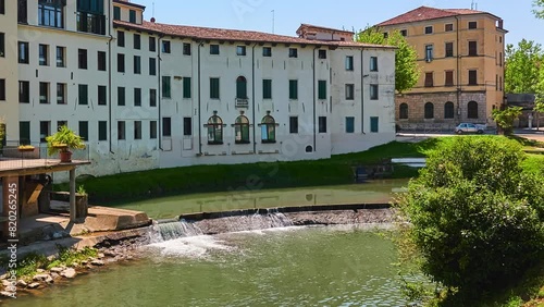 Old buildings on Stradella of Munari Street near Bacchiglione River in historic center of Vicenza, Italy. View from the bridge to Contra Pusterla Street.