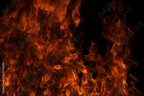 Fire flames isolated on black background. Fire burn flame isolated, flaming burning art design concept with space for text. photo