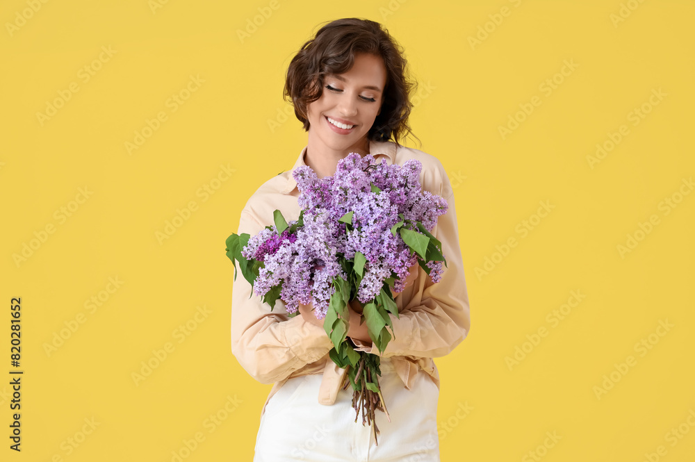 Beautiful young woman with bouquet of blooming lilac flowers on yellow background Beautiful young woman with bouquet of blooming lilac flowers on yellow background