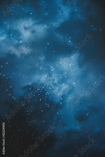 Vertical image capturing the beauty of a twinkling star-filled night sky amidst ethereal clouds