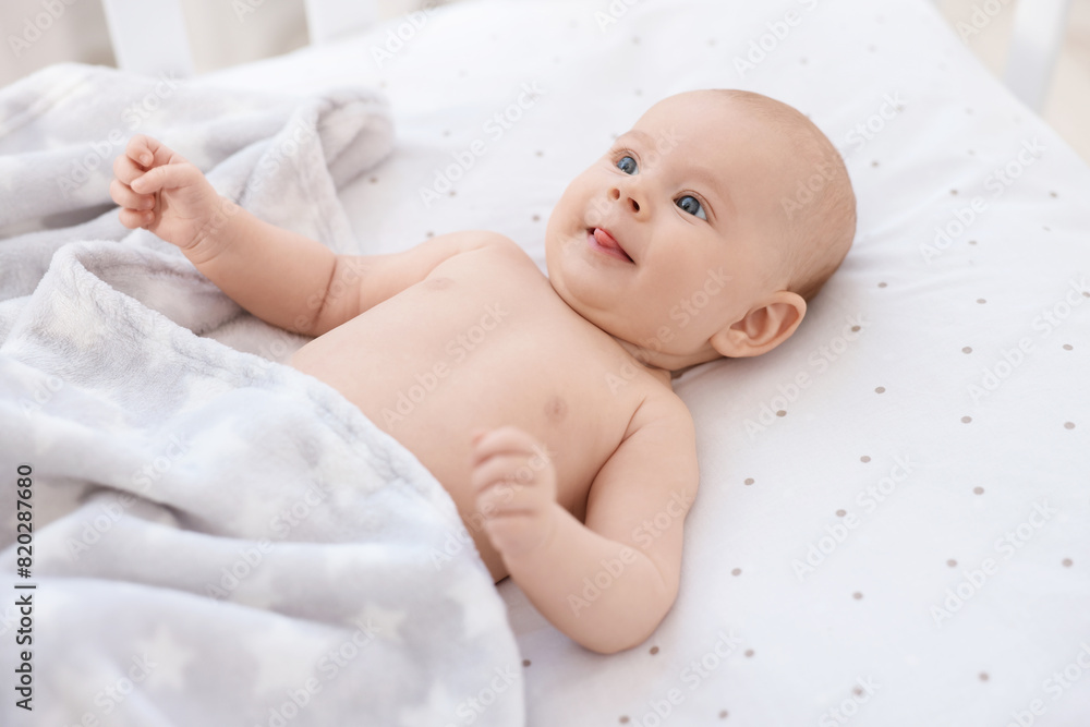 Cute little baby lying in crib at home Cute little baby lying in crib at home