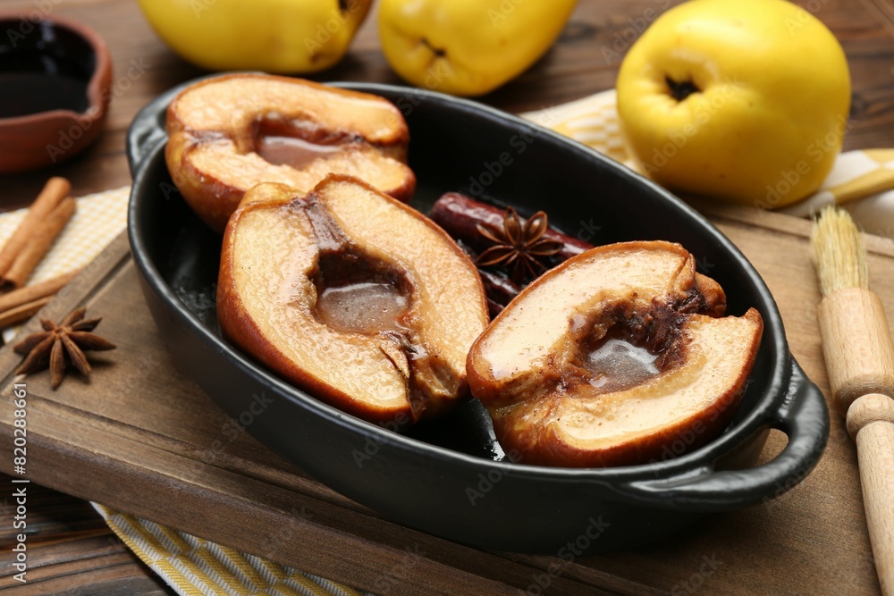 Tasty baked quinces with spices and honey in dish on table, closeup Tasty baked quinces with spices and honey in dish on table, closeup