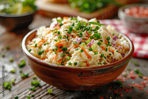Homemade creamy coleslaw in a rustic bowl garnished with green onions  perfect for restaurant menus and culinary guides.