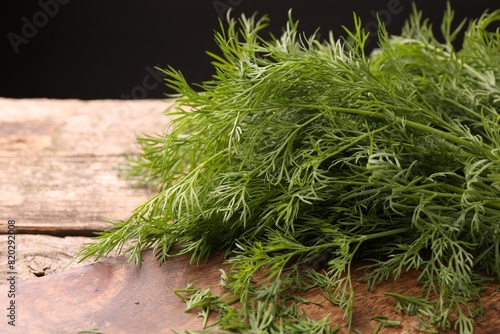 Fresh dill on wooden table, closeup. Space for text