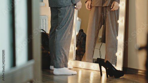 Fotografie Homosexual man looking in mirror and stroking head
