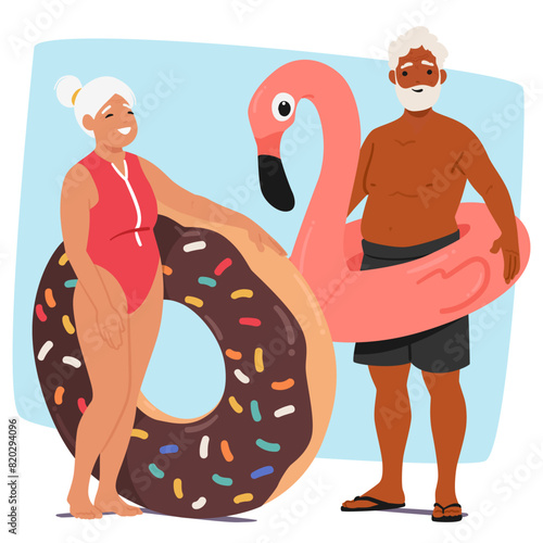 Cheerful Senior Couple Stands Ready For Pool Party, Woman Holding A Chocolate Donut Inflatable Ring And Man Flamingo One