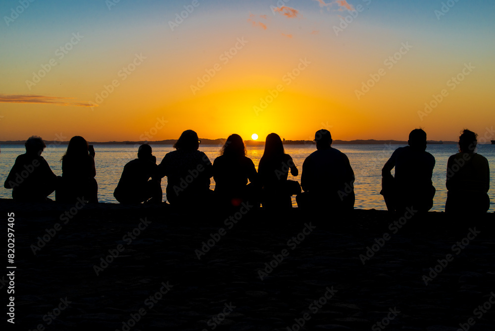Silhouette of people enjoying the dramatic sunset. Silhouette of people enjoying the dramatic sunset.