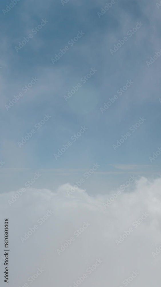 View of the blue sky while being above the clouds. Panorama of rushing clouds on a high mountain.