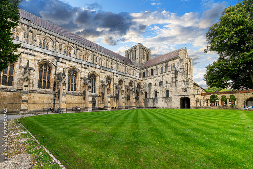 The stone arched buttresses and garden area along the south transept of the medieval Winchester Cathedral, in Winchester, Hampshire, England UK.
The stone arched buttresses and garden area along the south transept of the medieval Winchester Cathedral, in Winchester, Hampshire, England UK.