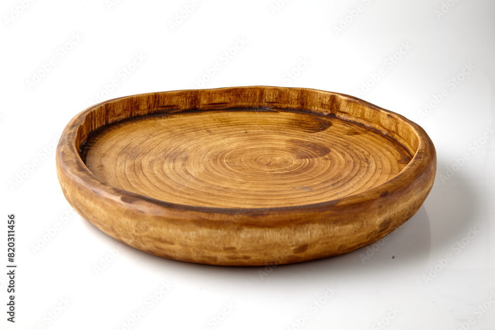 Handmade wooden brown plate isolated on white background. Platform for presentation and sale of food Handmade wooden brown plate isolated on white background. Platform for presentation and sale of food