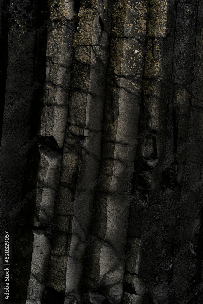 Vertical view of dark basalt columns of Reynisfjara black beach in Iceland Vertical view of dark basalt columns of Reynisfjara black beach in Iceland