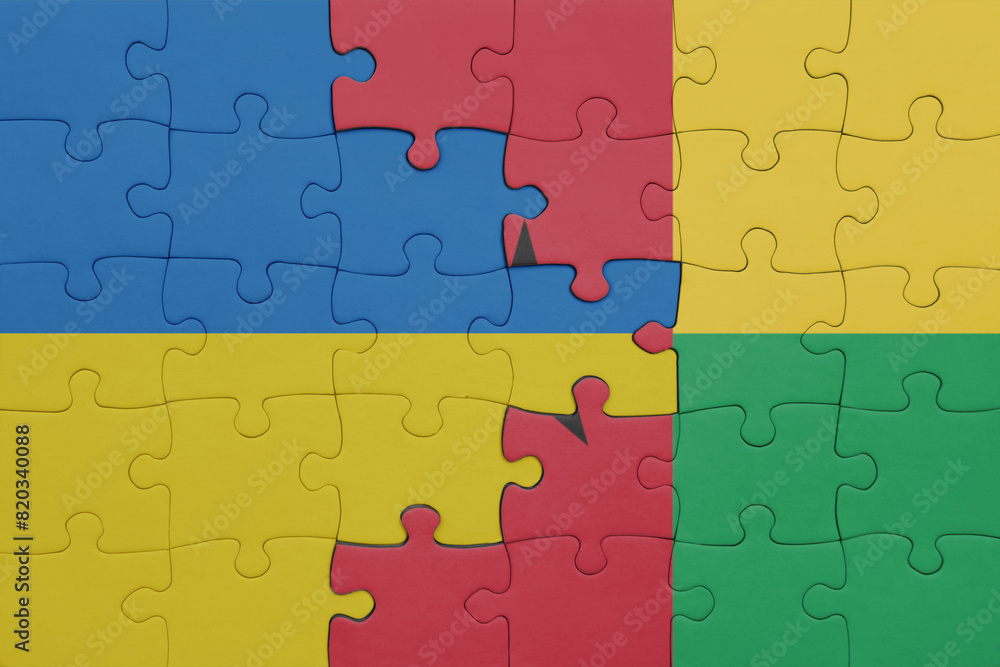 puzzle with the colourful national flag of guinea bissau and flag of ukraine. puzzle with the colourful national flag of guinea bissau and flag of ukraine.