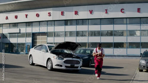 Wallpaper Mural Car mechanic dances with joy near vehicle at auto service center automobile repair shops car maintenance dancing by car. Mechanic displays positive dance moves near car auto service repair centers. Torontodigital.ca