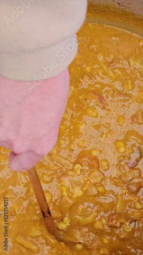 vertical video of step-by-step preparation of traditional Argentine food for national holidays at a family reunion with a huge pot for many portions 27