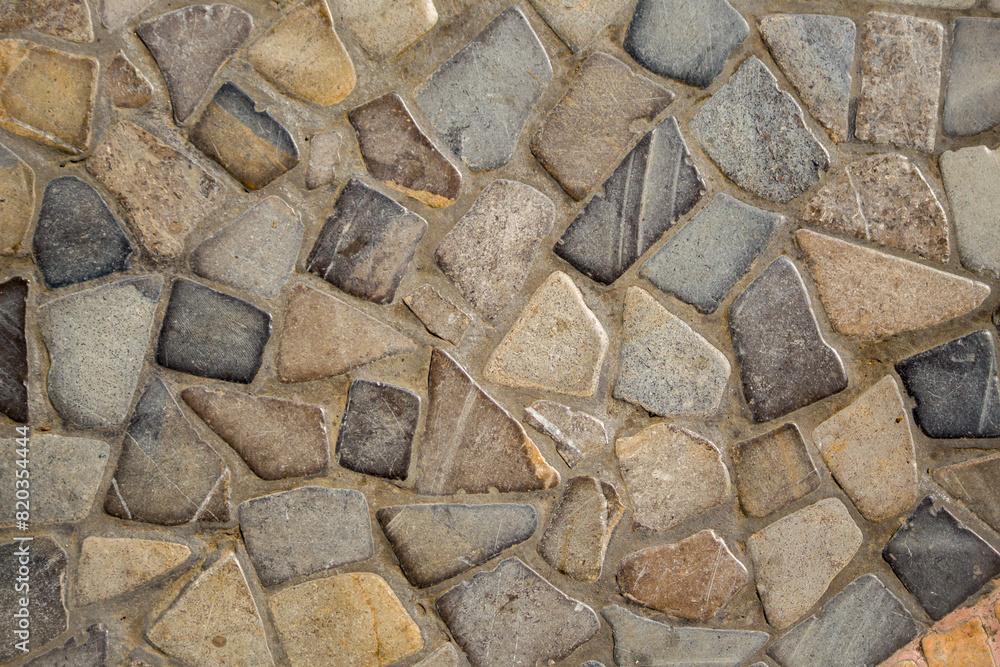 The background texture of the natural stone wall is arranged with cement