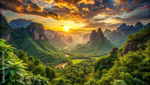 A verdant valley carpeted with lush foliage, framed by rugged mountains and bathed in the warm glow of the setting sun. photo