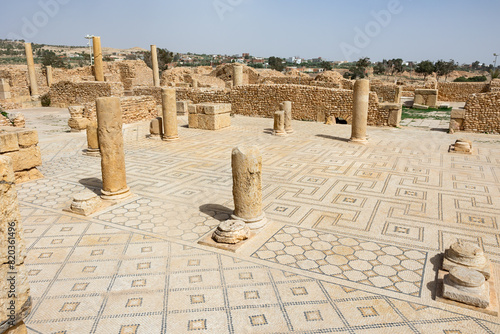 Remains of ancient Roman thermes bathing-place, built of light sandstone during Roman colonization era. Ancient city of Sufetula on African continent in modern Tunisia photo