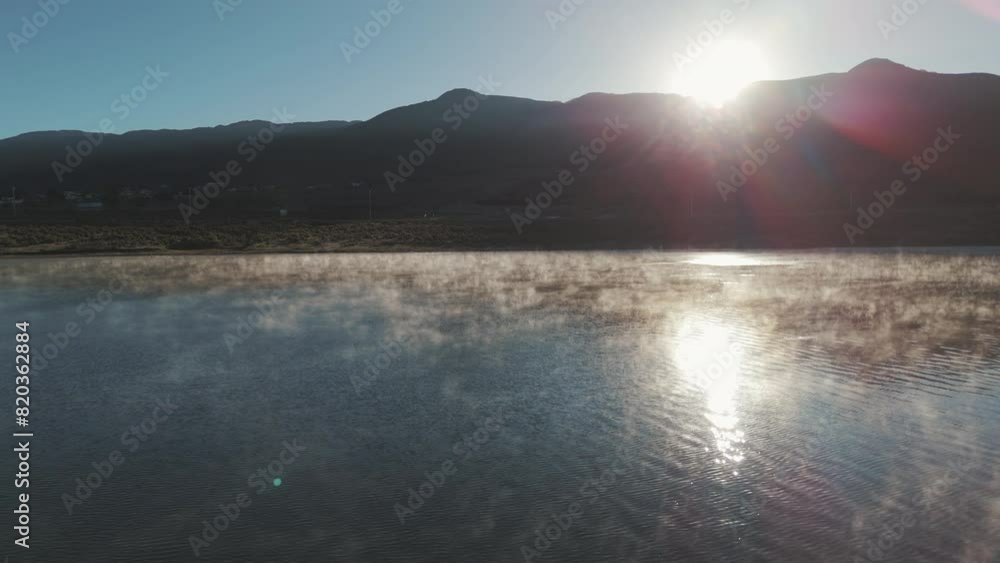 Aerial Push-Pan Over Water Toward Desert Mountain Landscape And Sunset In The Distance. Beautiful Fog And Reflections On The Water. Dique la Angostura In Tafí del Valle, Tucumán, Argentina Aerial Push-Pan Over Water Toward Desert Mountain Landscape And Sunset In The Distance. Beautiful Fog And Reflections On The Water. Dique la Angostura In Tafí del Valle, Tucumán, Argentina