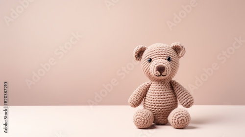 Cute and cuddly crocheted teddy bear made from beige yarn. © narak0rn