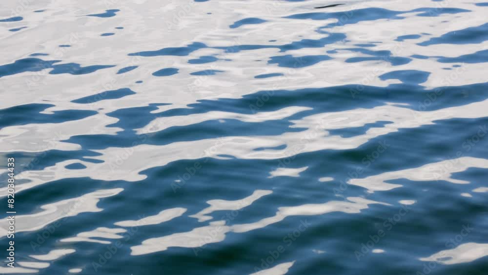 Moving bluish water surface with small waves on the lake Moving bluish water surface with small waves on the lake