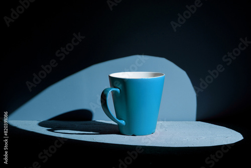 Simple blue ceramic mug on blue background