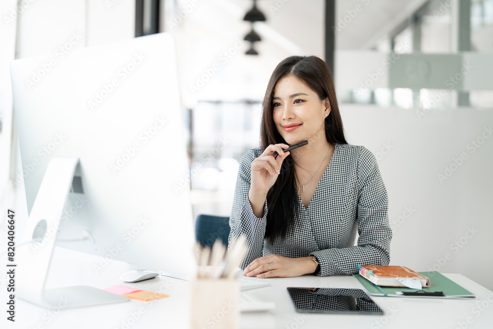 Image of young beautiful joyful woman smiling while working in office Image of young beautiful joyful woman smiling while working in office