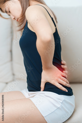 woman having back body ache during at home. adult female with muscle pain due to Piriformis Syndrome, Low Back Pain and Spinal Compression. Office syndrome and medical concept