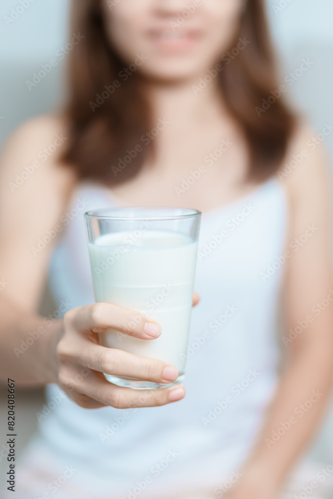 Milk drink and Daily Routine concept. Young woman Drinking milk with high calcium and nutrition at home, woman holding soy milk on glass with protein. Healthy, wellness and happy lifestyle Milk drink and Daily Routine concept. Young woman Drinking milk with high calcium and nutrition at home, woman holding soy milk on glass with protein. Healthy, wellness and happy lifestyle