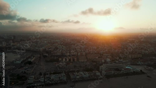 Enchanting Sunset Over Bustling Coastal Cityscape, Captured at Dusk