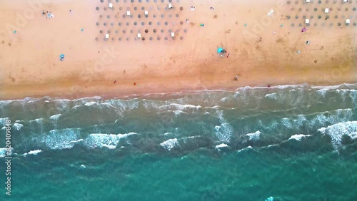 Aerial View of Serene Beach With Sun Loungers and Gentle Waves at Sunset