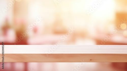 Empty light brown wooden table top with a warm, bright, blurred background perfect for product display montage or presentation