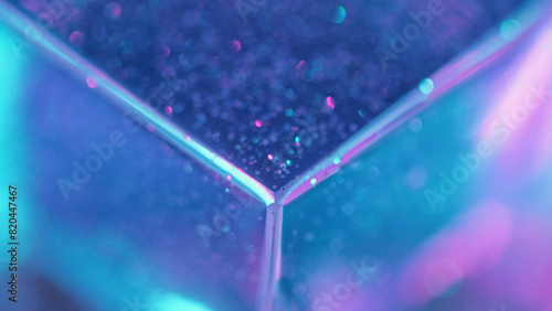 Neon cube. Bokeh light. Defocused fluorescent blue pink purple color glow flare glass prism texture geometric abstract background.
