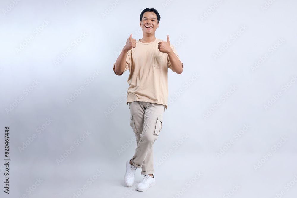 Full Body Of Stylish Young Asian Guy Giving Thumbs Up Isolated On White Background Full Body Of Stylish Young Asian Guy Giving Thumbs Up Isolated On White Background