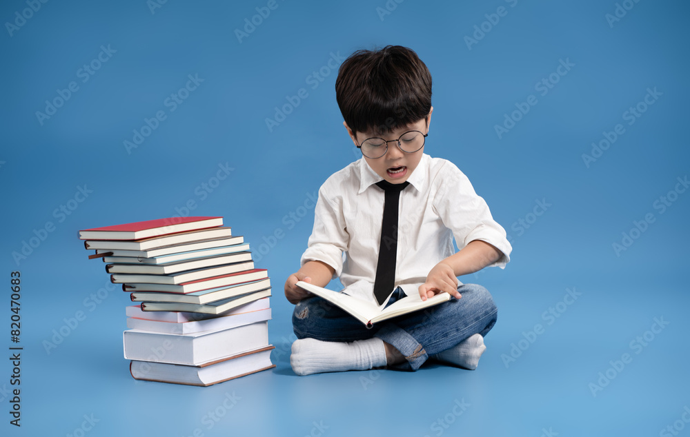 Full body image of Asian school boy posing on blue background Full body image of Asian school boy posing on blue background